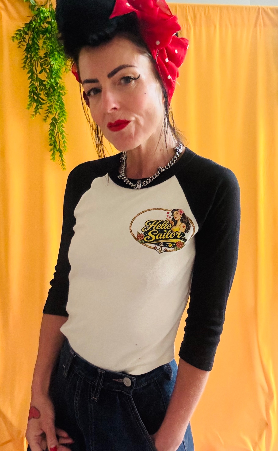 Retro Sweetheart raglan tee front with red bow print on yellow backdrop