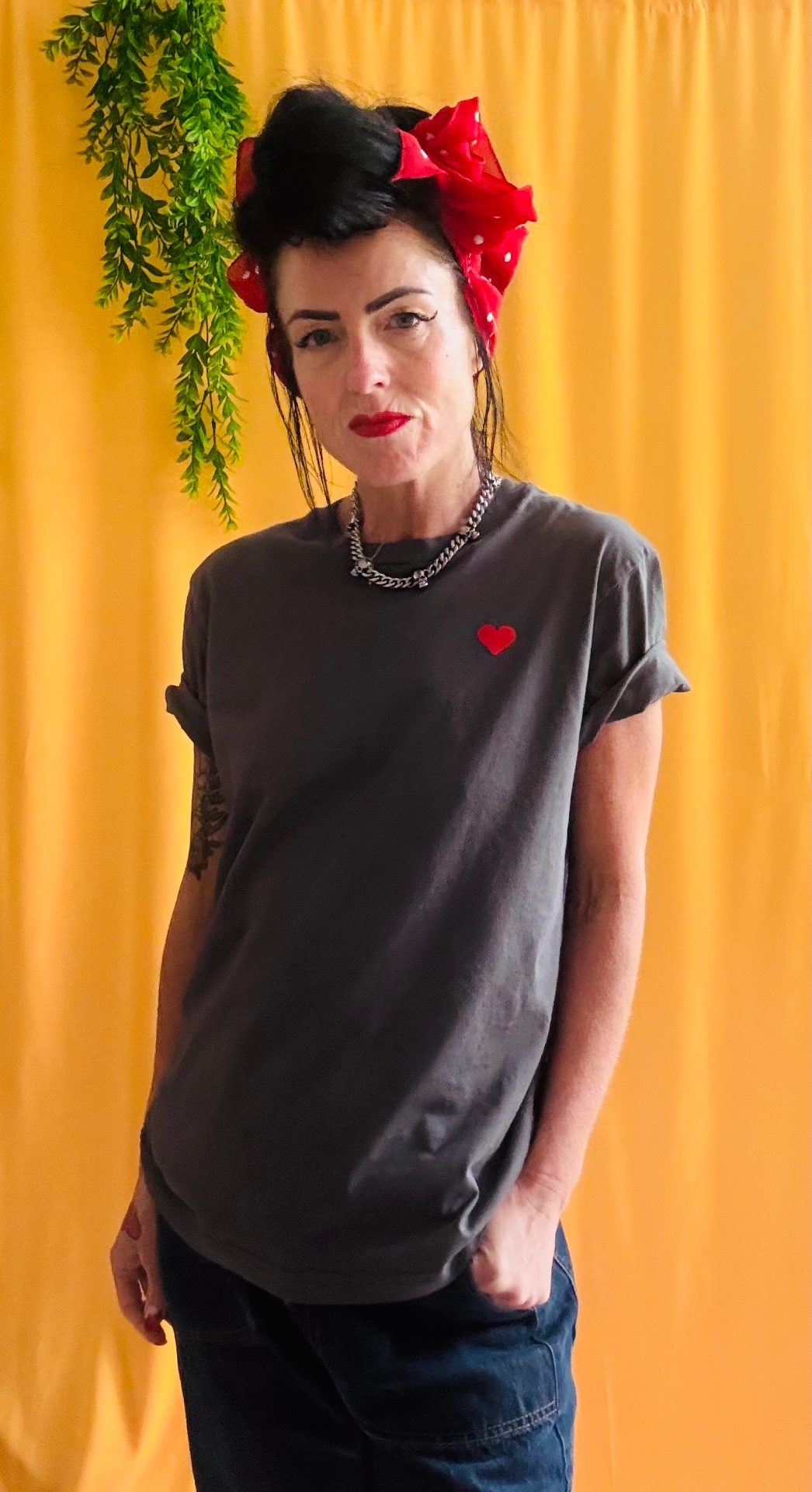 Bottoms Up Darlings tee front with small red heart print on yellow backdrop
