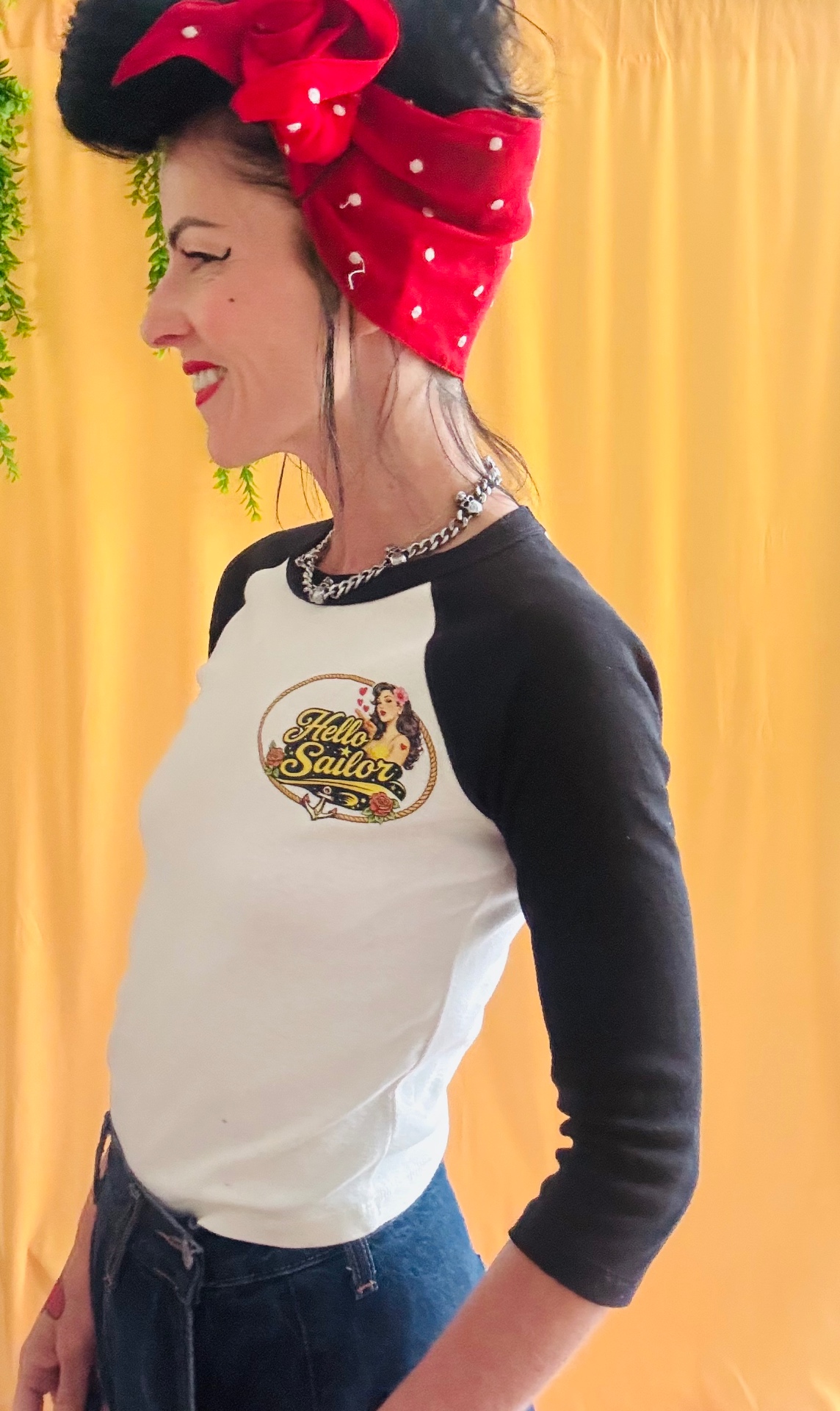 Retro Sweetheart raglan tee side view showing the raglan sleeve fit on yellow backdrop