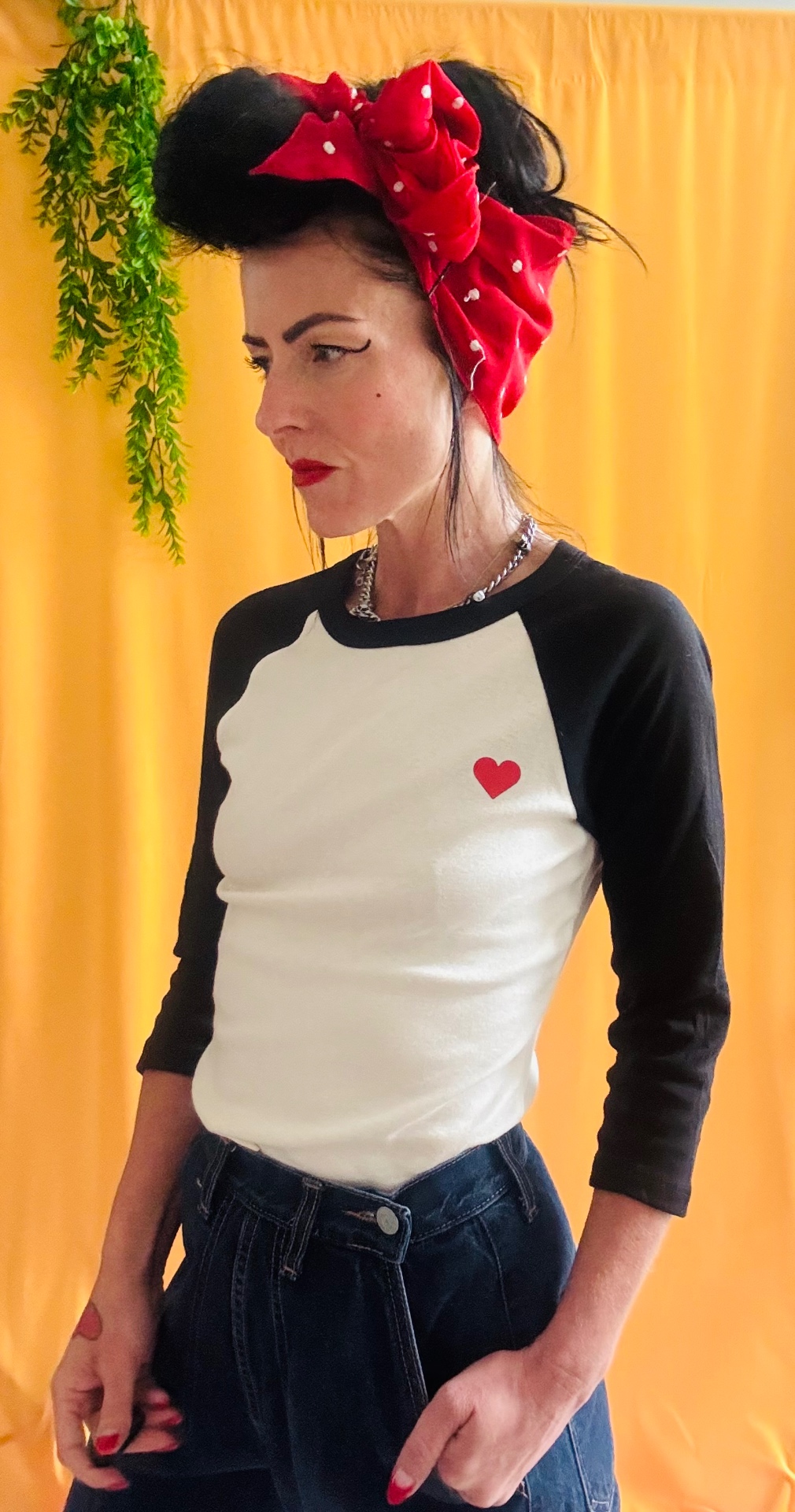 Beach Babe raglan tee front with small heart print on yellow backdrop
